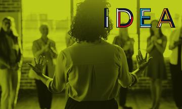 A women talking and gesturing with her hands to a group of women, with a green gradient overlay and IDEA logo
